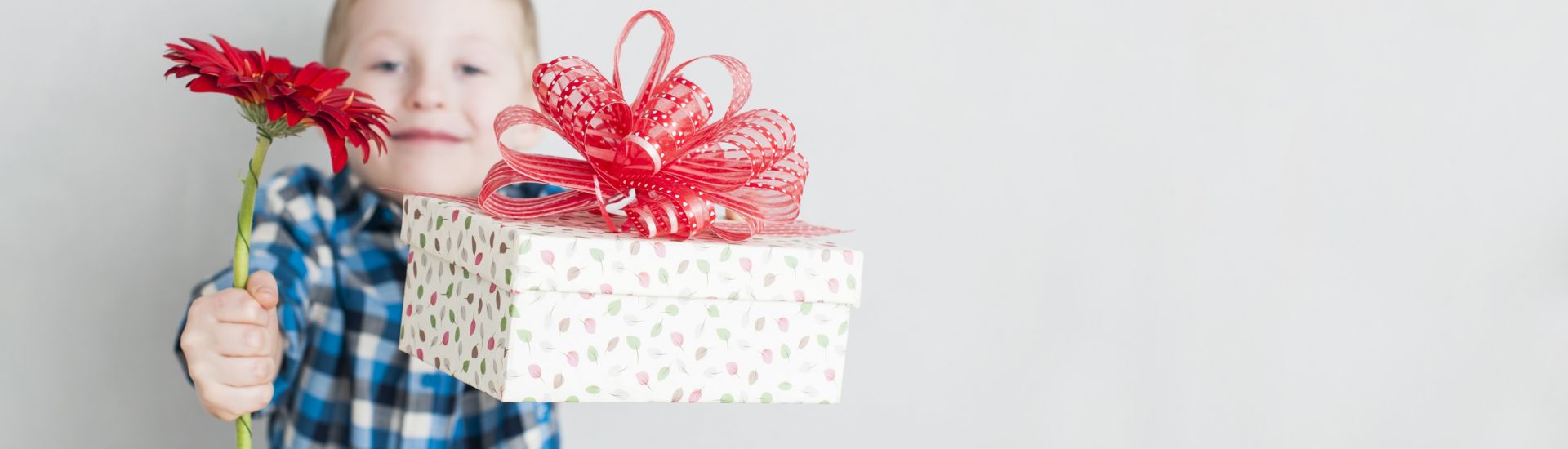 little boy with red flower and gift box