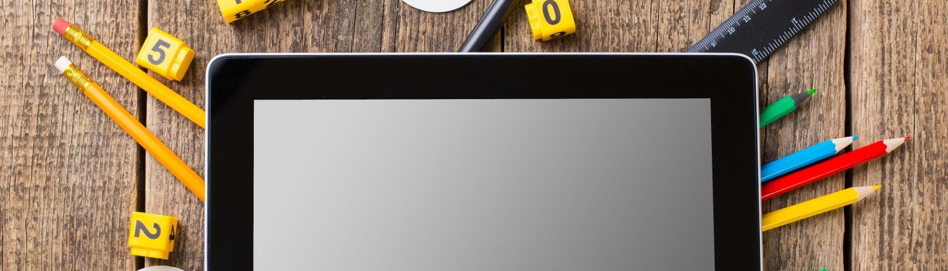 Composite image of digital tablet on students desk showing back