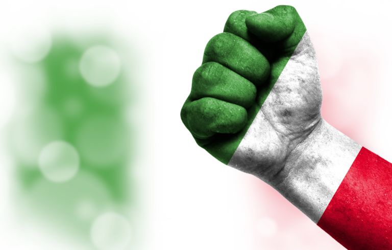 Flag of Italy painted on male fist, concept of conflict