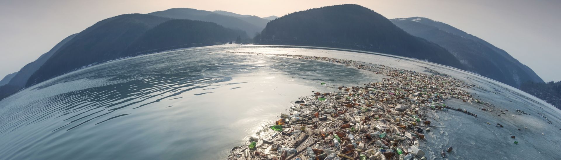 Spring flood and shore with garbage