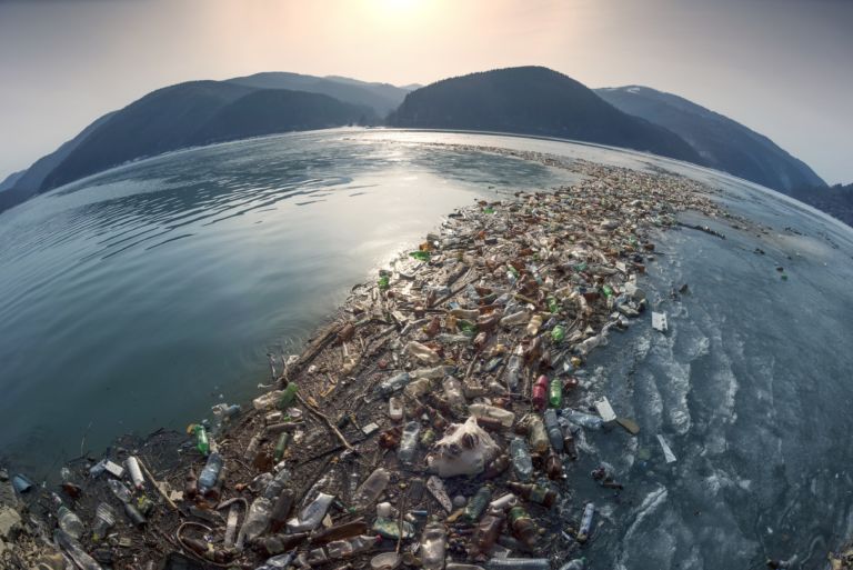 Spring flood and shore with garbage