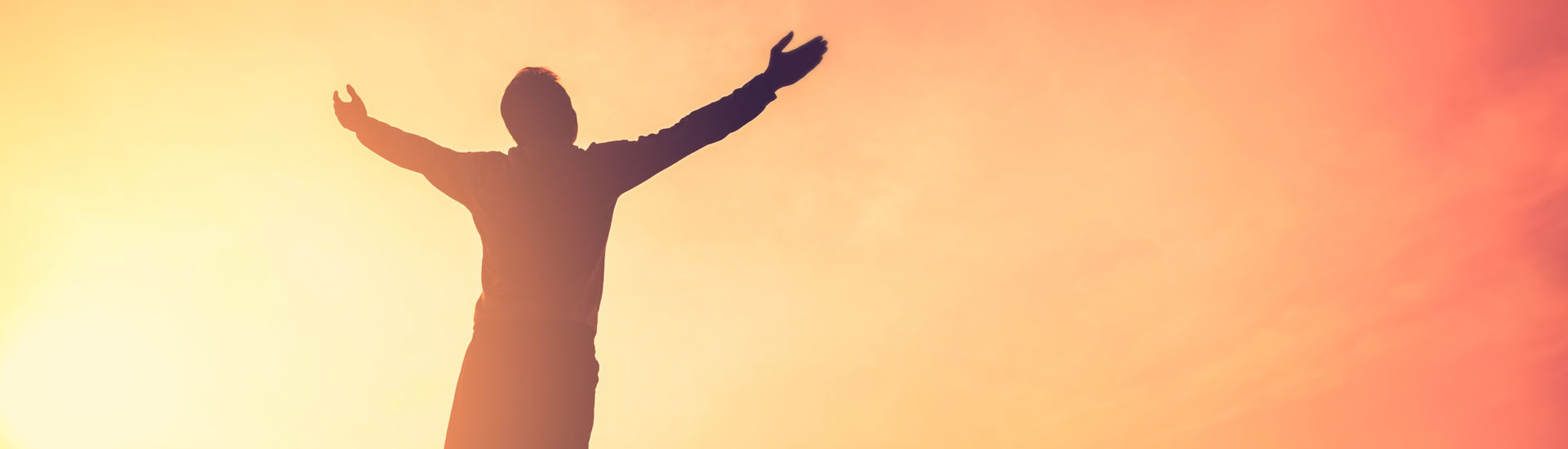 Copy space of man rise hand up on top of mountain and sunset sky abstract background.