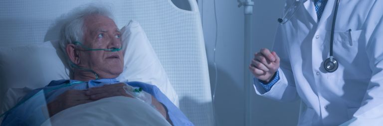 Elder patient looking at doctor
