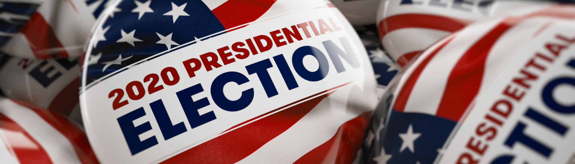 Closeup shot of one presidential election button in focus in between many other buttons in a box. Selective focus with shallow depth of field.