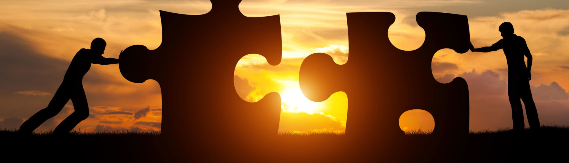 Two men connect two puzzle pieces. Concept of business solution, solving a problem.