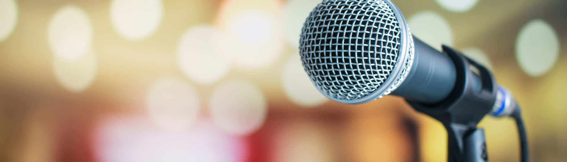 Microphone for speaker on abstract blurred of speech in seminar room or speaking conference for audience at university