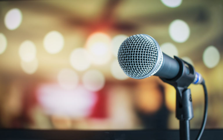 Microphone for speaker on abstract blurred of speech in seminar room or speaking conference for audience at university