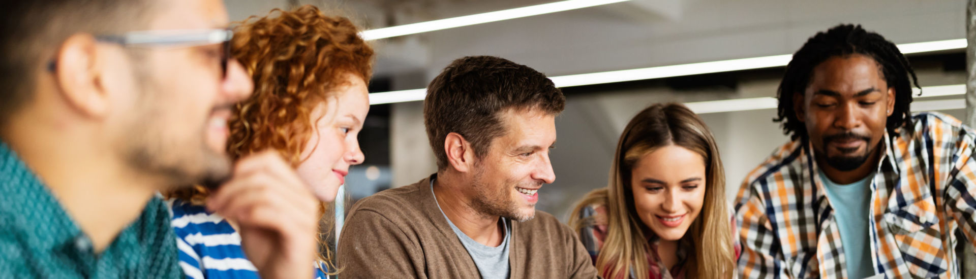Group of diverse designers, business people brainstorming on meeting in office