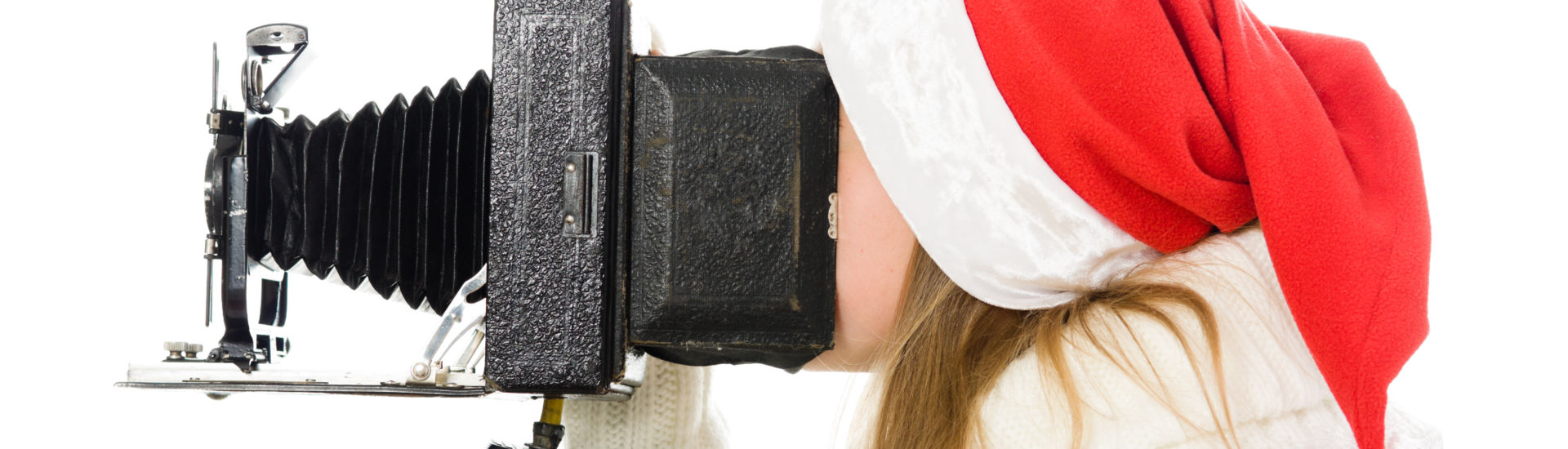 Girl in a Christmas costume with old camera