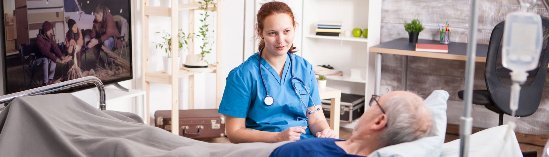 Female doctor with stethoscope sharing comfort to old man