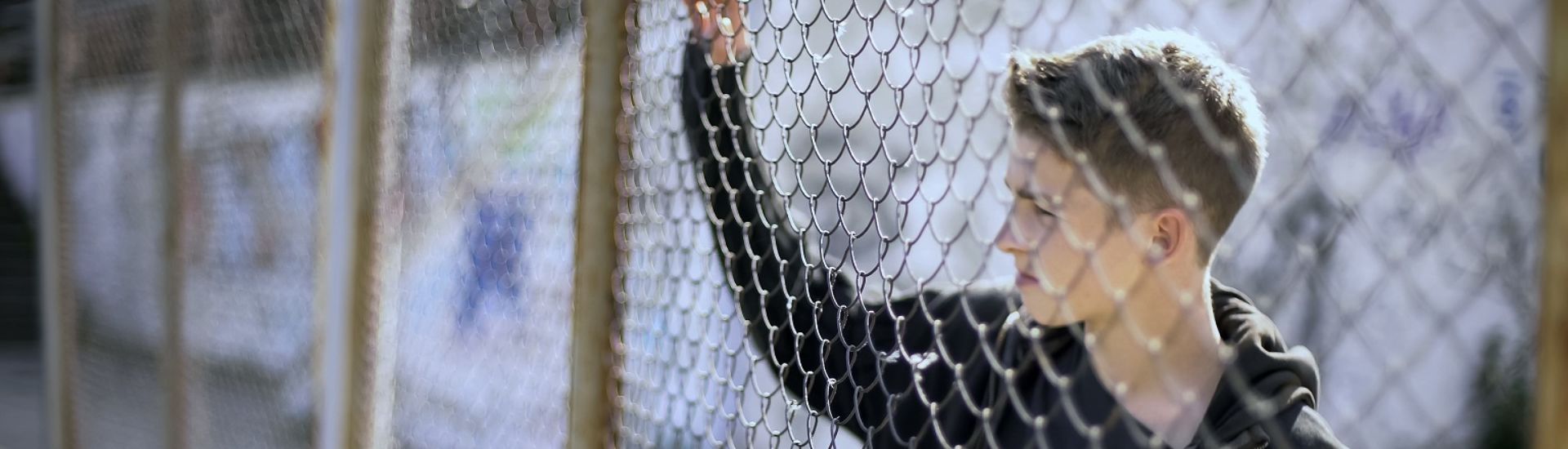 Boarding school restrictions, teen boy behind fence confinement, broken future