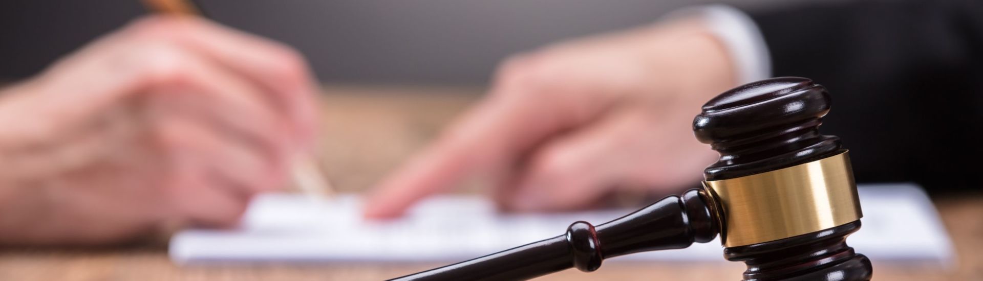 Close-up Of A Gavel On Wooden Desk