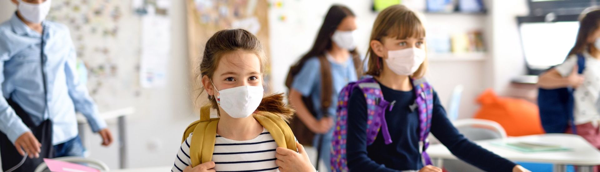 Group of children with face mask back at school after covid-19 quarantine and lockdown.