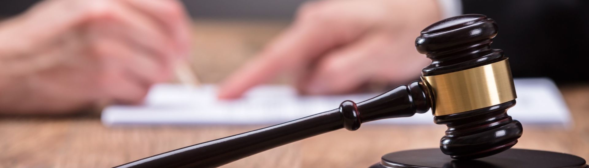 Close-up Of A Gavel On Wooden Desk