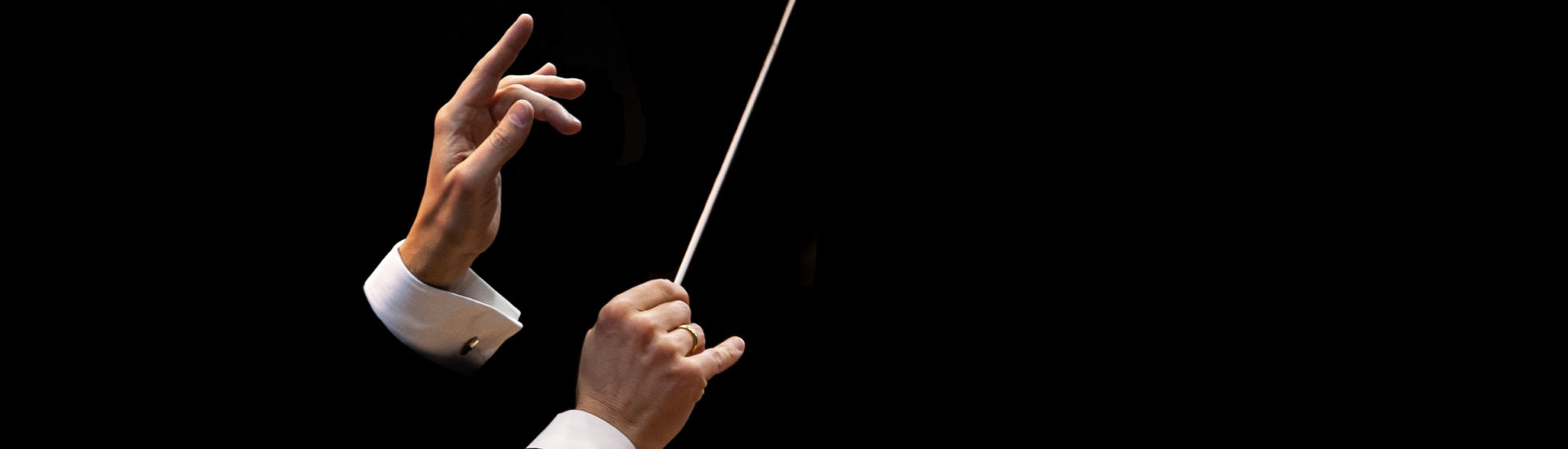 Conductor’s hands on a black background