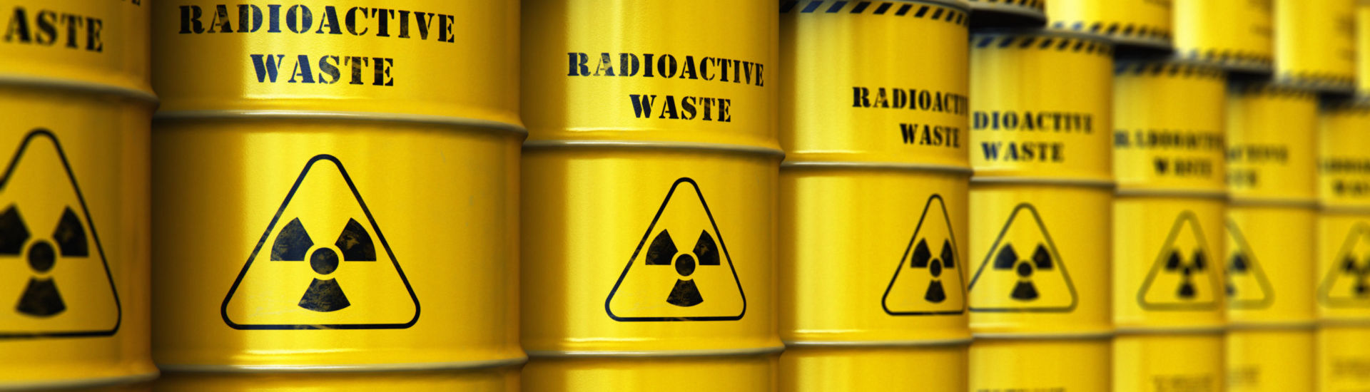 Group of stacked yellow drums with radioactive waste