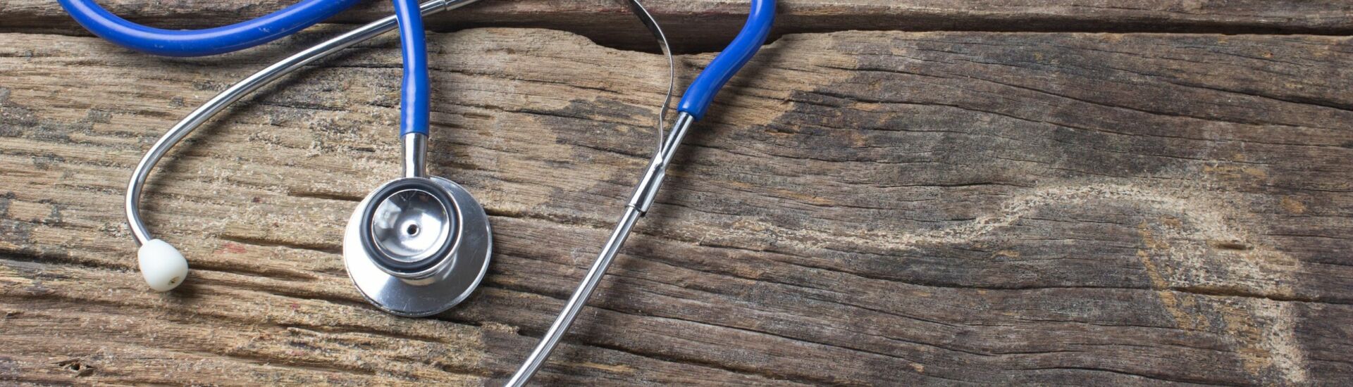 Stethoscope on wooden health .background concept.