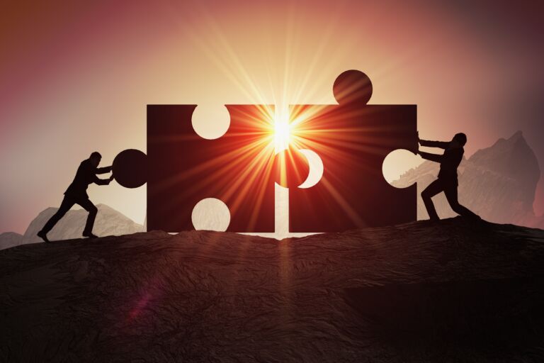 Teamwork, partnership and cooperation concept. Silhouettes of tw