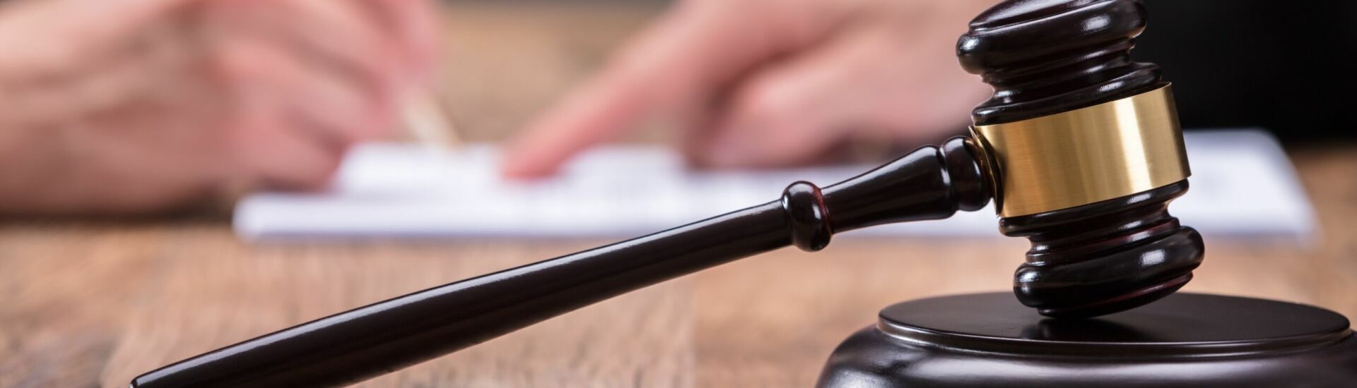 Close-up Of A Gavel On Wooden Desk