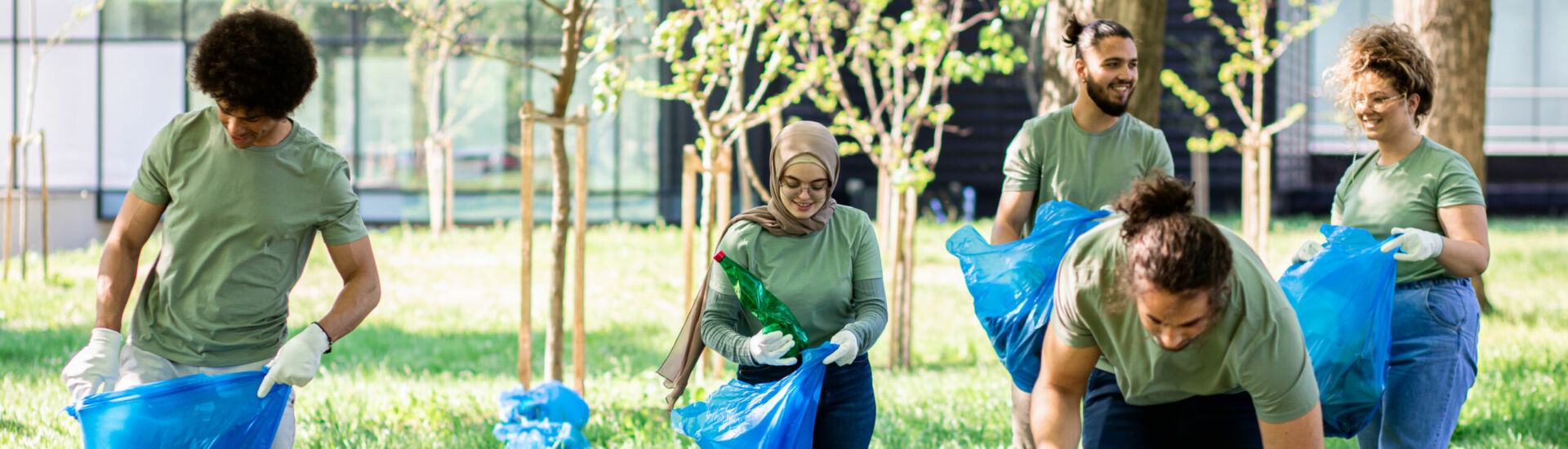 Multiethnic group of volunteers with garbage bags cleaning city