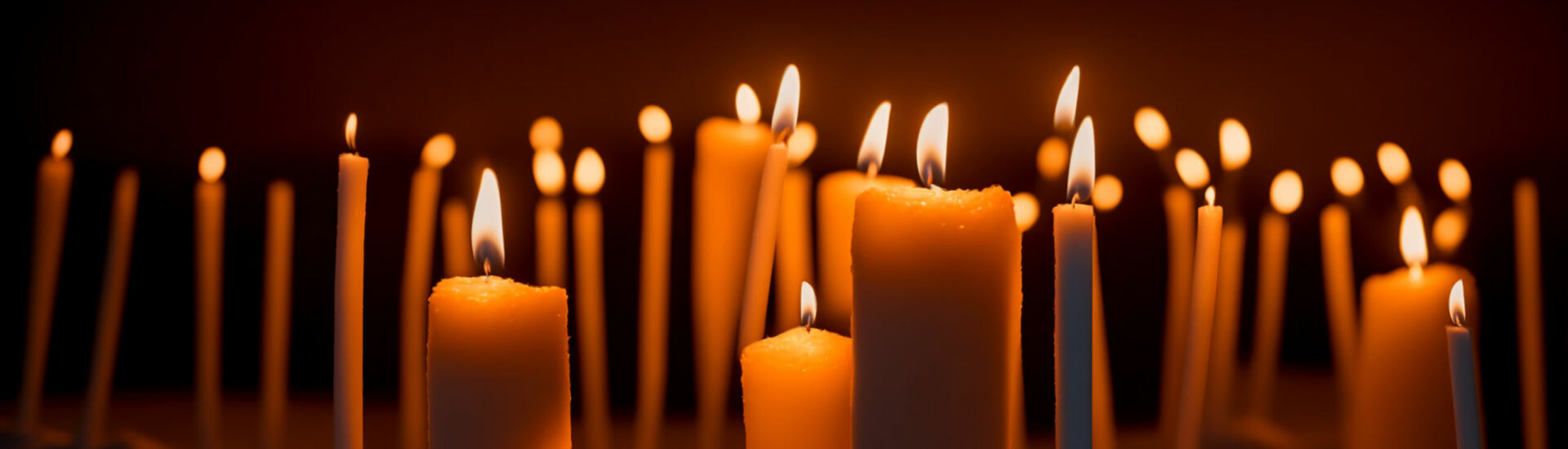 Many candles in beach sand at night