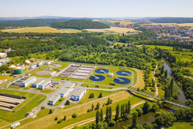 Aerial view of sewage treatment plant. Industrial water treatment for big city from drone view. Waste water management.