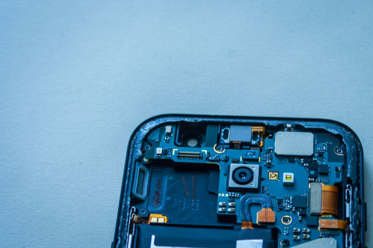 Repair faulty mobile phone on desk. concept of computer hardware, mobile phone, electronic, repairing, upgrade and technology.