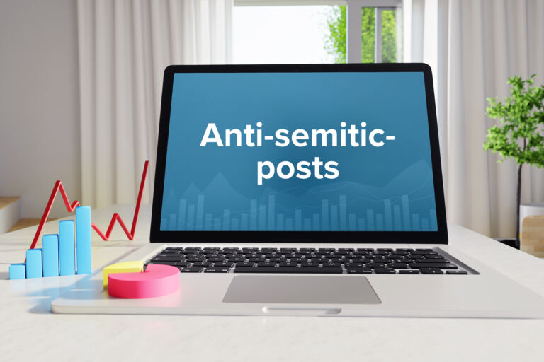 Anti-semitic-posts. Statistics/Business. Laptop in the office with term on the Screen. Finance/Economy.
