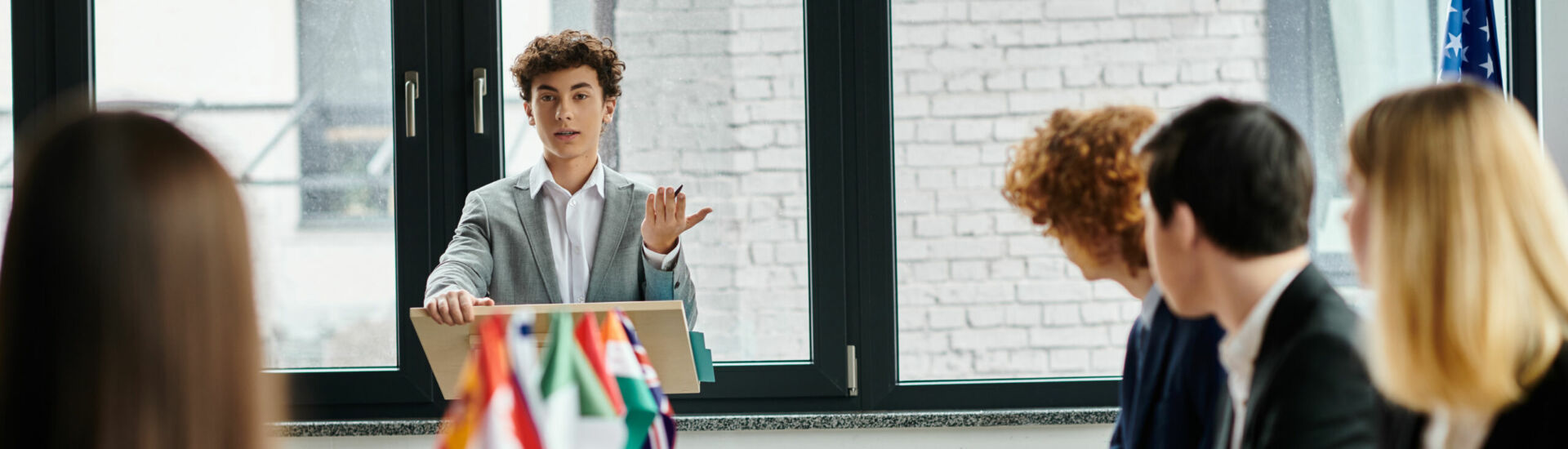 Teenagers participate in a United Nations Model conference, engaging in diplomatic discourse.