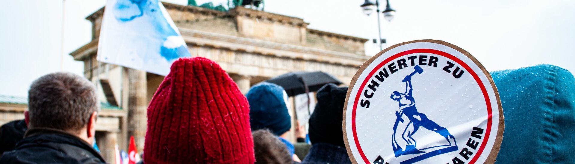 Peace movement in Berlin, in front of Brandenburg Gate with people holding signs