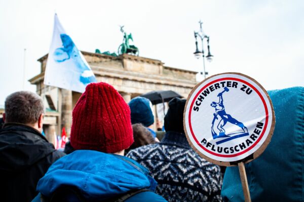 Peace movement in Berlin, in front of Brandenburg Gate with people holding signs