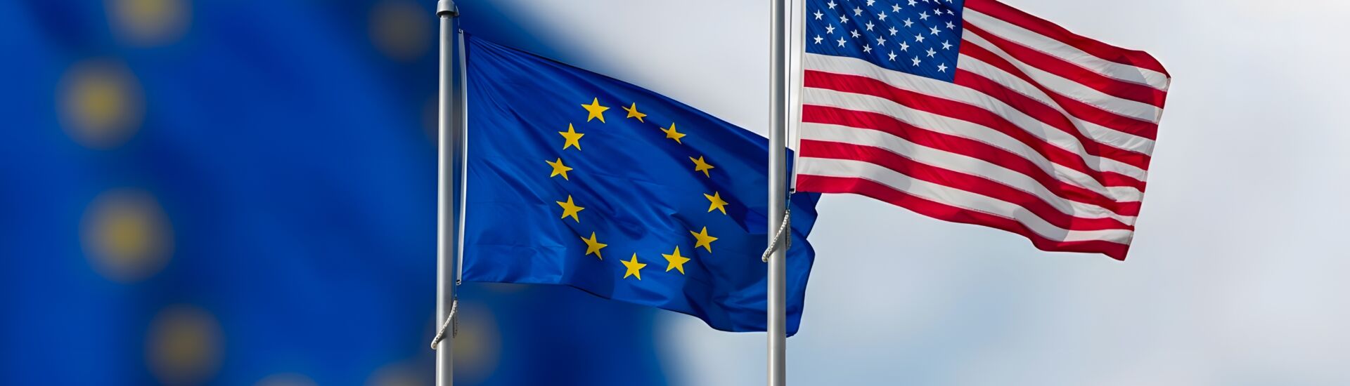 Flags of European Union and USA Waving Together on Flagpoles