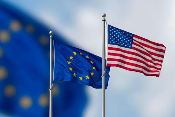 Flags of European Union and USA Waving Together on Flagpoles