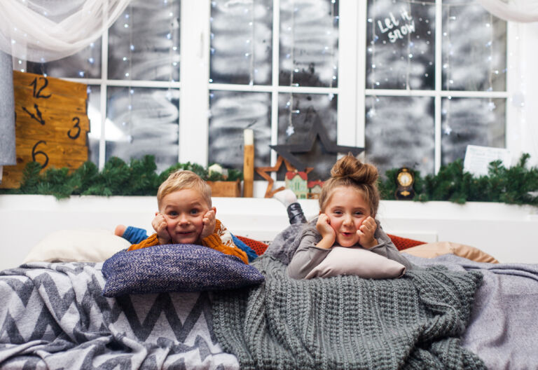 Cute little kids, boy and girl at home waiting for Santa Claus